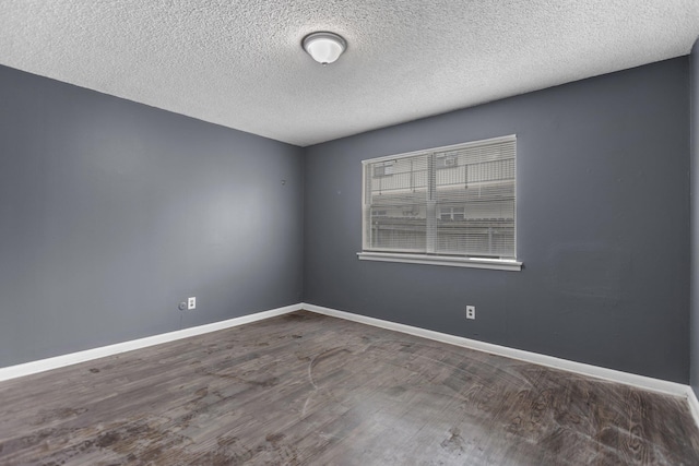 7305 Kentucky Ave, Little Rock, AR 72207 - unfurnished room featuring dark wood-type flooring and a textured ceiling