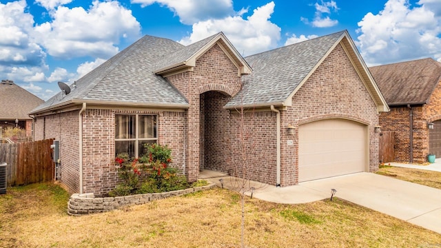 view of front of home with a garage and a front lawn