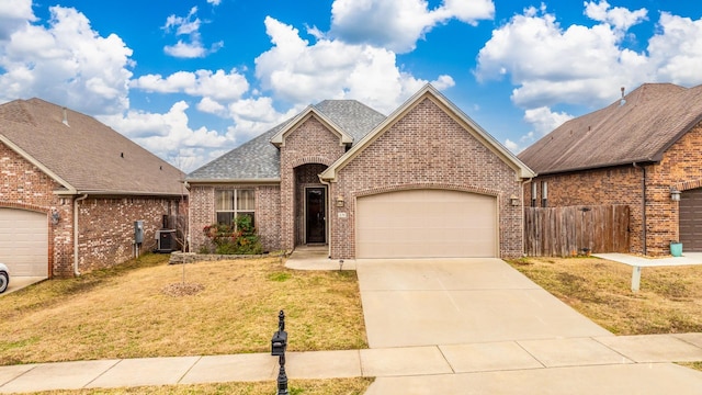 view of front of house featuring central AC unit, a garage, and a front lawn