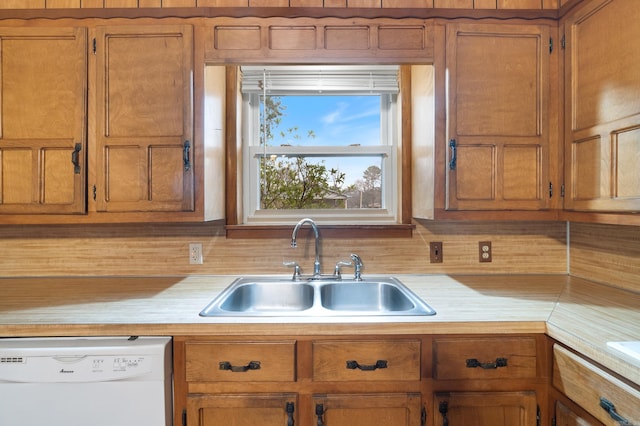 kitchen with dishwasher, sink, and backsplash