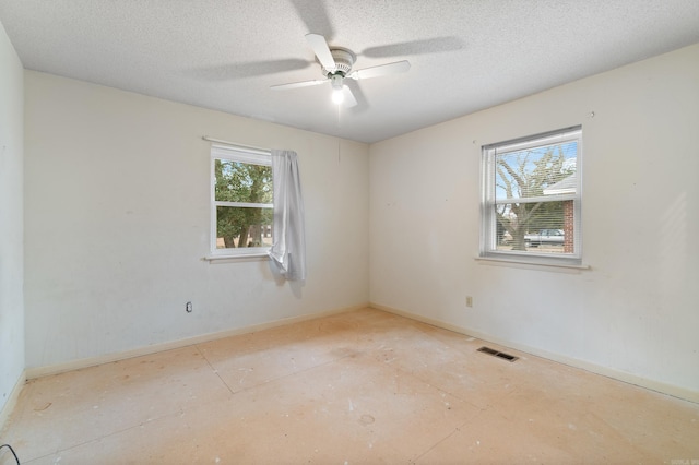 spare room featuring ceiling fan and a textured ceiling