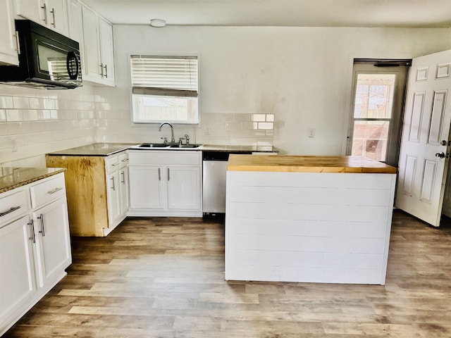 kitchen featuring dishwasher, sink, wooden counters, white cabinets, and light wood-type flooring