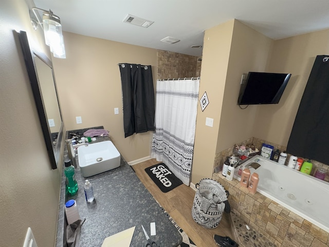 bathroom featuring vanity, shower with separate bathtub, and hardwood / wood-style floors