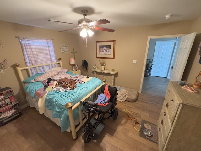 bedroom with hardwood / wood-style floors and ceiling fan