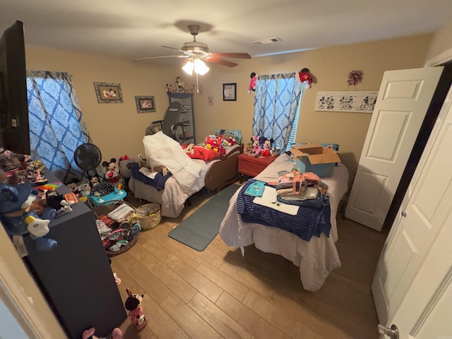 bedroom featuring wood-type flooring and ceiling fan