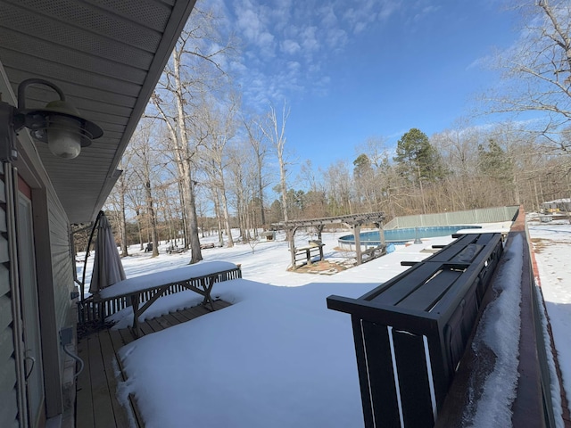 snowy yard featuring a pergola