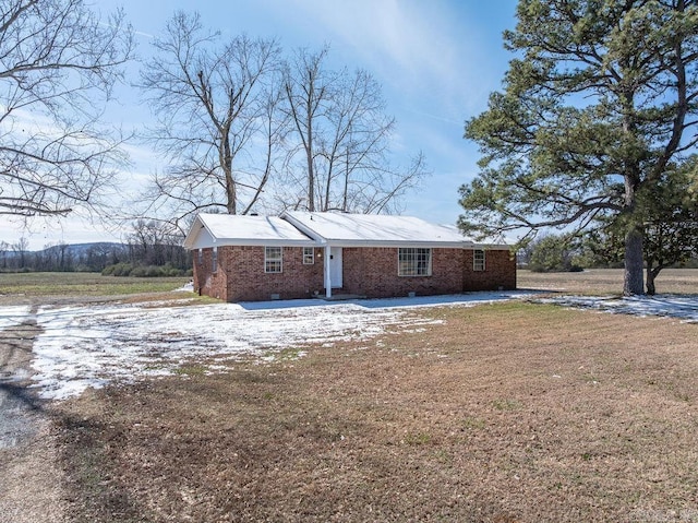 view of property exterior with crawl space and brick siding