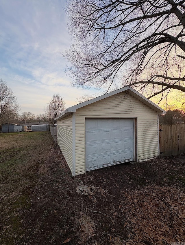 view of garage at dusk