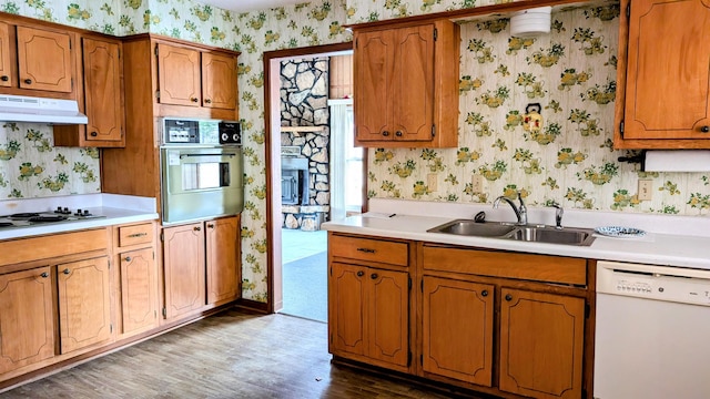 kitchen featuring white appliances, sink, and dark hardwood / wood-style floors