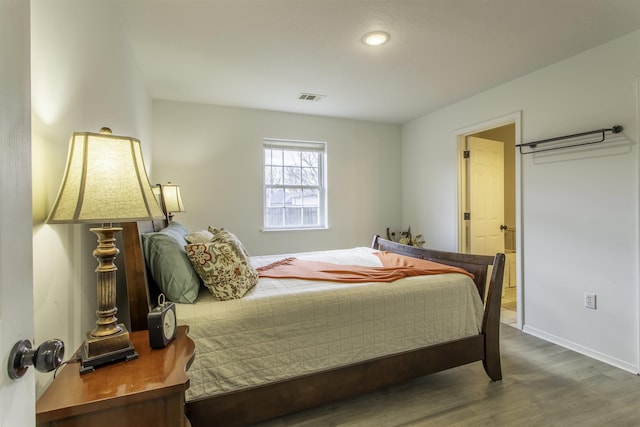 bedroom with hardwood / wood-style flooring