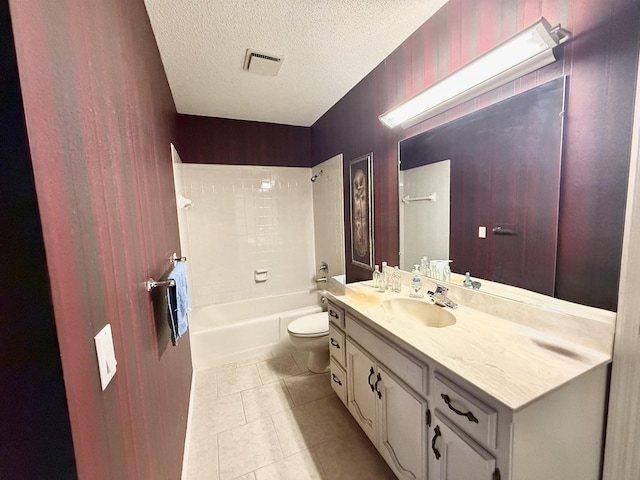 full bathroom featuring shower / bath combination, vanity, toilet, tile patterned floors, and a textured ceiling