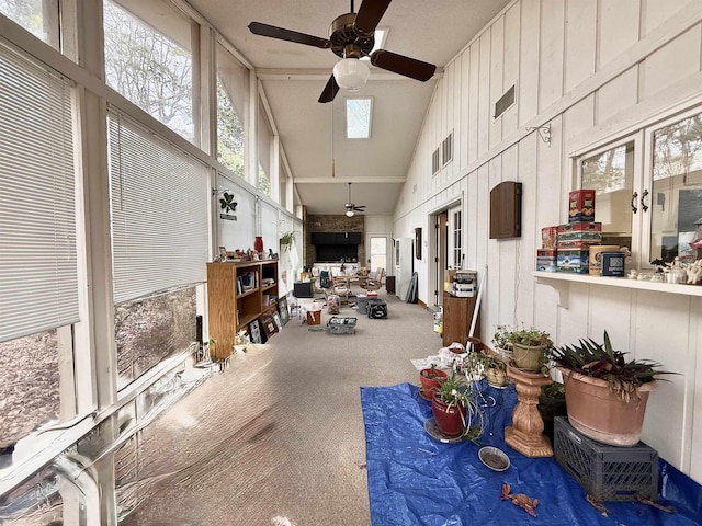 miscellaneous room featuring carpet floors, high vaulted ceiling, and ceiling fan