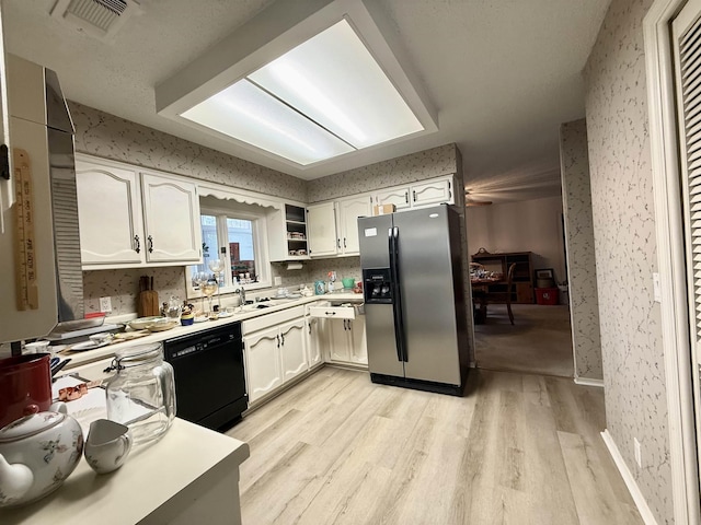 kitchen featuring light hardwood / wood-style floors, dishwasher, stainless steel fridge with ice dispenser, and white cabinets