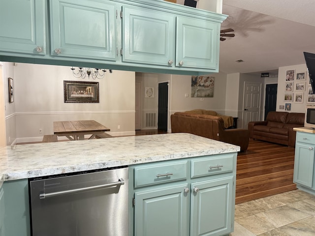 kitchen featuring stainless steel dishwasher, kitchen peninsula, and green cabinetry