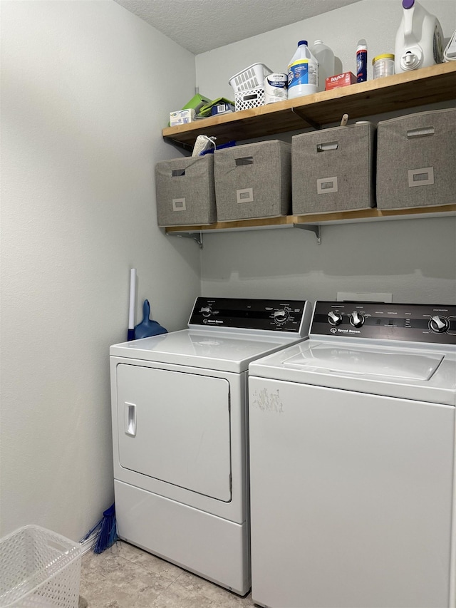 laundry room featuring washer and dryer and a textured ceiling