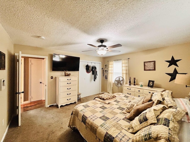 carpeted bedroom with a textured ceiling, a closet, and ceiling fan