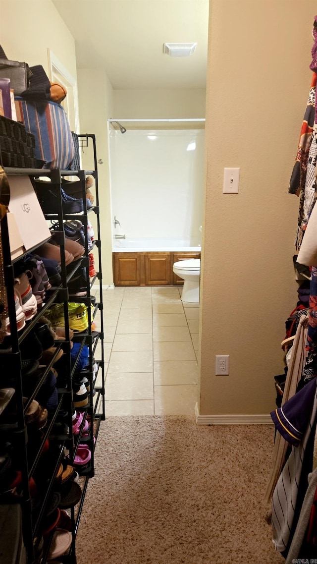 bathroom featuring toilet and tile patterned flooring