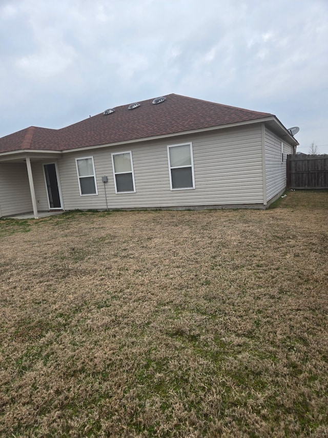 rear view of property with a lawn