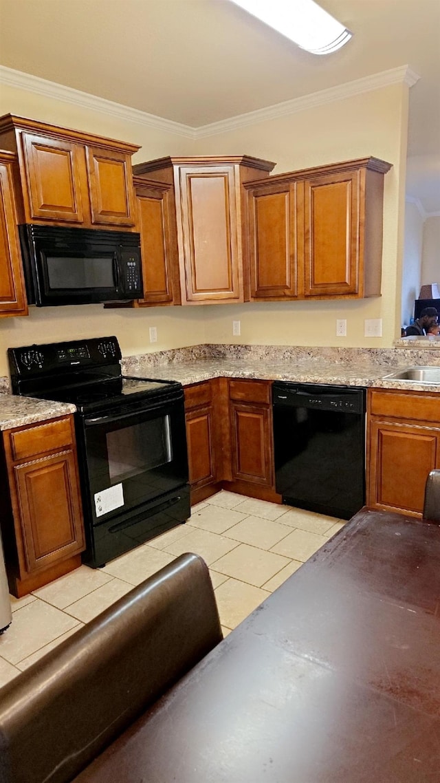 kitchen featuring sink, light tile patterned floors, ornamental molding, and black appliances