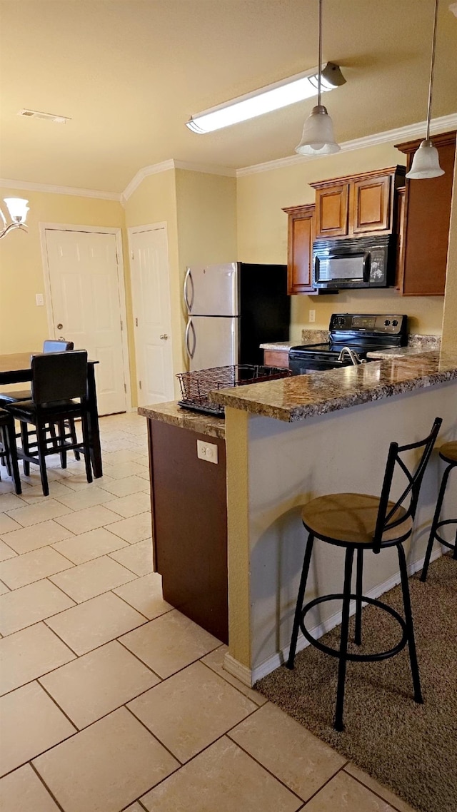 kitchen featuring hanging light fixtures, ornamental molding, black appliances, and kitchen peninsula