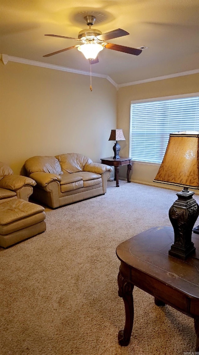 carpeted living room with ceiling fan and ornamental molding