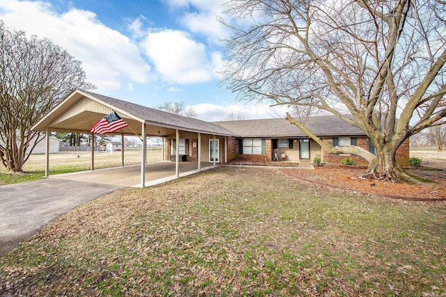 view of front facade with a carport and a front lawn