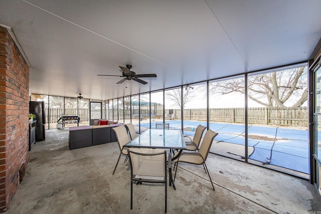 unfurnished sunroom featuring ceiling fan