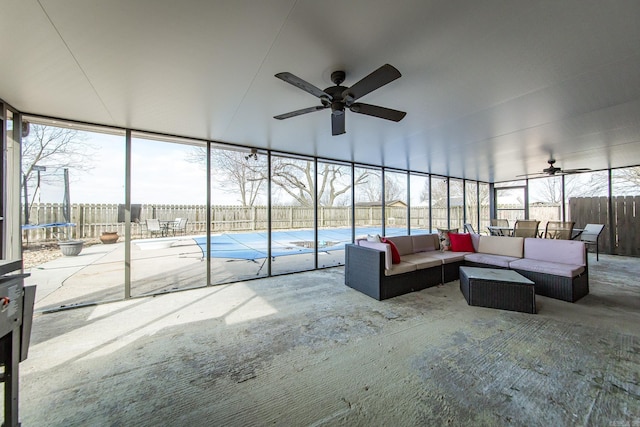 unfurnished sunroom featuring ceiling fan