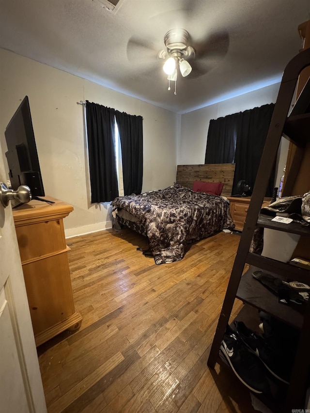 bedroom featuring wood-type flooring and ceiling fan