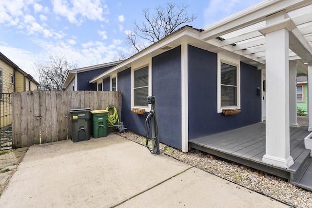 view of side of property featuring a patio and a pergola