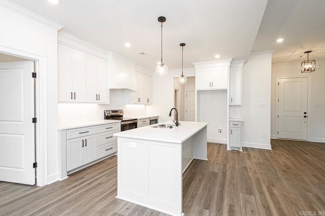 kitchen featuring sink, a center island with sink, electric range, custom range hood, and white cabinets