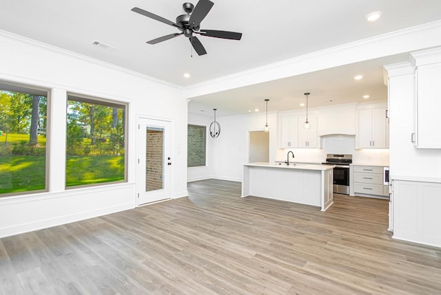 kitchen with a kitchen island with sink, hanging light fixtures, stainless steel range with electric cooktop, and white cabinets