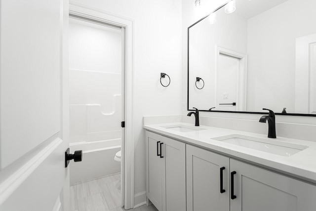 full bathroom featuring vanity, toilet, and shower / washtub combination