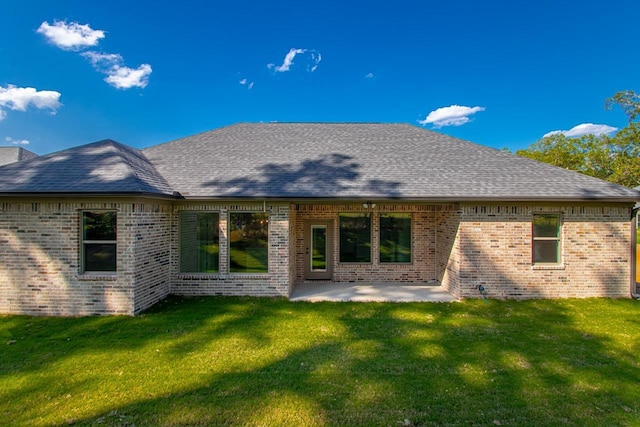 rear view of property featuring a yard and a patio