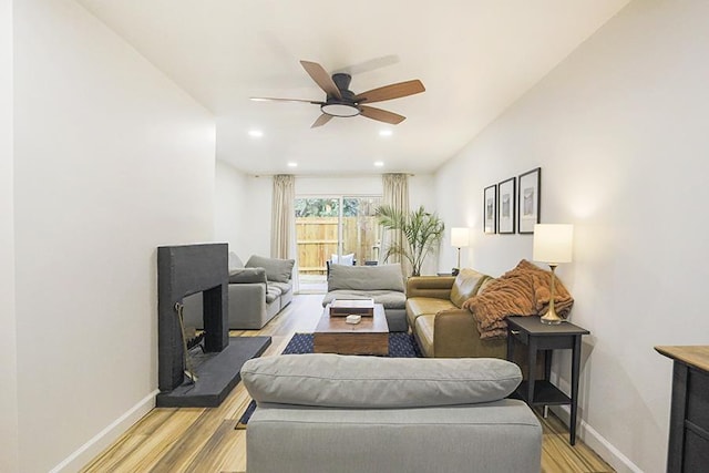 living room with ceiling fan and light hardwood / wood-style floors