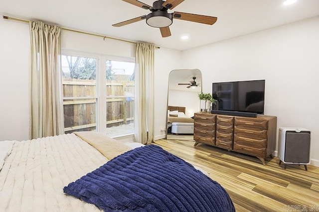 bedroom with light hardwood / wood-style flooring and ceiling fan