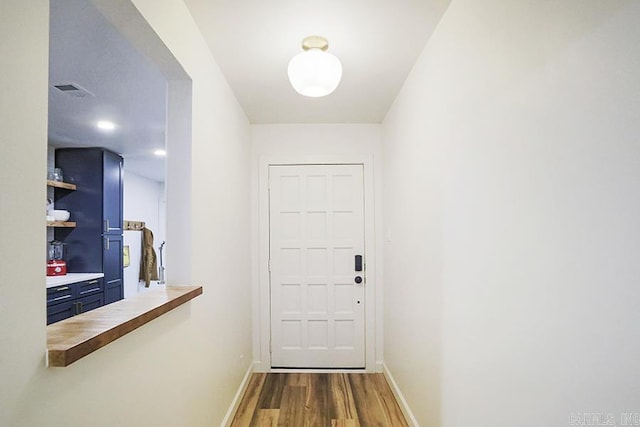 doorway with hardwood / wood-style floors