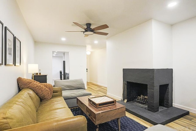 living room with ceiling fan and hardwood / wood-style floors