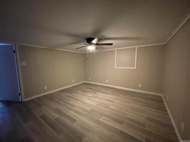 empty room featuring crown molding, ceiling fan, and wood-type flooring