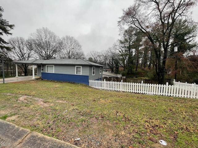 view of front facade with a carport and a front yard