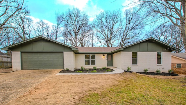 ranch-style house featuring a garage and a front lawn