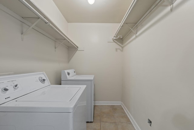 1601 N Bryant St Unit C27, Little Rock, AR 72207 - clothes washing area featuring washing machine and clothes dryer and light tile patterned flooring