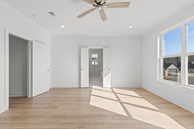 empty room featuring crown molding, recessed lighting, visible vents, light wood-type flooring, and baseboards