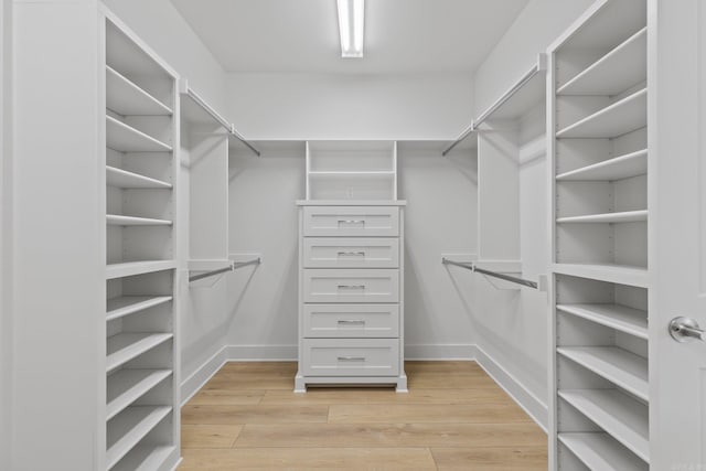 walk in closet featuring light wood finished floors