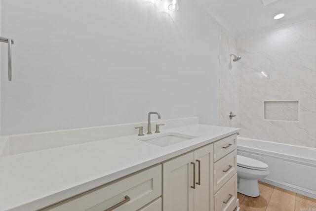 bathroom with toilet, shower / bathtub combination, wood finished floors, and vanity