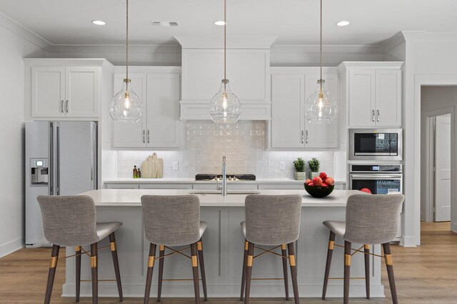 kitchen featuring white cabinetry, appliances with stainless steel finishes, and light countertops