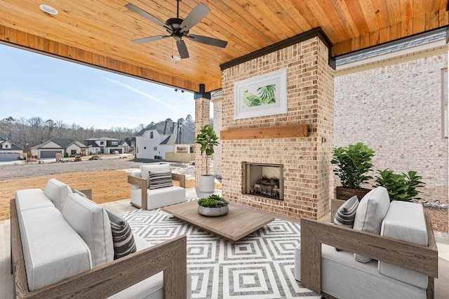 view of patio / terrace with a ceiling fan, a residential view, and an outdoor living space with a fireplace