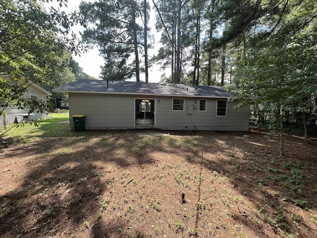 rear view of property with a lawn