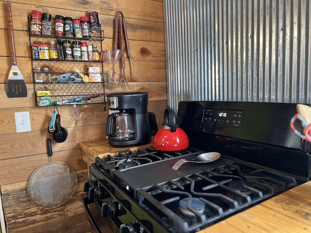 kitchen with wooden walls and gas stove