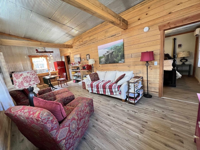 living room with wood walls, hardwood / wood-style floors, and vaulted ceiling with beams